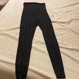 Women’s solid black maternity leggings with high belly band.